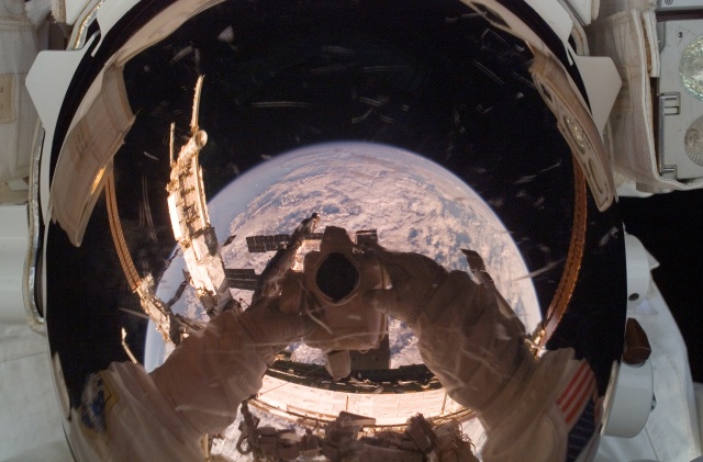 Cool reflection of Earth in an astronauts mirrored visor!